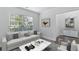 Cozy living room filled with natural light, a comfortable sofa, and contemporary decor, ideal for entertaining at 4353 Pond Edge Rd, Snellville, GA 30039