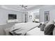 Bright primary bedroom featuring hardwood floors, television, ceiling fan, walk-in closet and sitting area at 4353 Pond Edge Rd, Snellville, GA 30039