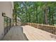 Expansive wooden deck in a private backyard surrounded by lush trees and greenery at 5702 Brynwood Nw Cir, Acworth, GA 30101