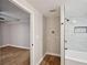 Bathroom area showcases washer-dryer hookups, a shower, and a doorway leading to a living space at 5702 Brynwood Nw Cir, Acworth, GA 30101
