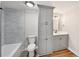Bathroom features a vanity, built-in storage, and a tiled shower-tub at 5702 Brynwood Nw Cir, Acworth, GA 30101