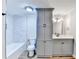 Bright bathroom features gray cabinets, tile, and a shower-tub combination at 5702 Brynwood Nw Cir, Acworth, GA 30101