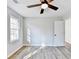 Plank flooring in a bedroom with a ceiling fan and a window at 5702 Brynwood Nw Cir, Acworth, GA 30101