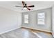 This bedroom boasts plank flooring, a ceiling fan, and great natural light at 5702 Brynwood Nw Cir, Acworth, GA 30101