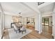 Open dining area with modern lighting, hardwood floors, and views into the living room and backyard at 5702 Brynwood Nw Cir, Acworth, GA 30101