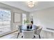 Cozy dining room features a round table, modern chandelier, and large windows at 5702 Brynwood Nw Cir, Acworth, GA 30101
