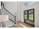 Welcoming entryway featuring a modern black railing staircase and double doors leading to the exterior at 5702 Brynwood Nw Cir, Acworth, GA 30101
