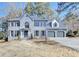 Traditional two-story home featuring a three-car garage and mature trees at 5702 Brynwood Nw Cir, Acworth, GA 30101
