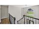 Foyer with a modern chandelier and large arched window overlooking the landscaped front yard at 5702 Brynwood Nw Cir, Acworth, GA 30101