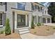 Stately gray brick home showcasing a welcoming front entrance with a double door entry and manicured landscaping at 5702 Brynwood Nw Cir, Acworth, GA 30101
