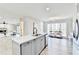 Open concept kitchen with a large island, quartz countertop, and stainless steel appliances connected to the living room at 5702 Brynwood Nw Cir, Acworth, GA 30101
