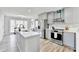 Modern kitchen featuring gray cabinets, stainless steel appliances, quartz countertops, and a large kitchen island at 5702 Brynwood Nw Cir, Acworth, GA 30101