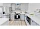 Bright and modern kitchen features stainless steel appliances and white quartz counters at 5702 Brynwood Nw Cir, Acworth, GA 30101