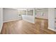 Large living space featuring light, wood-look floors, neutral paint, and windows at 5702 Brynwood Nw Cir, Acworth, GA 30101
