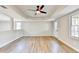 Bright living room features a ceiling fan and new laminate flooring at 5702 Brynwood Nw Cir, Acworth, GA 30101