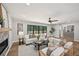 Cozy living room with fireplace, neutral furniture, hardwood floors, and sliding glass doors opening to the outdoor deck at 5702 Brynwood Nw Cir, Acworth, GA 30101