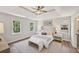 Bright main bedroom features a tray ceiling, a ceiling fan, and two large windows at 5702 Brynwood Nw Cir, Acworth, GA 30101