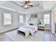 Bright main bedroom with a tray ceiling, ceiling fan, and ample natural light at 5702 Brynwood Nw Cir, Acworth, GA 30101