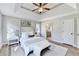 Bright main bedroom with a tray ceiling, ceiling fan, and ensuite bathroom access, creating a tranquil retreat at 5702 Brynwood Nw Cir, Acworth, GA 30101