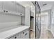 Mudroom with gray cabinets, white countertop, and a sliding barn door, providing storage and style at 5702 Brynwood Nw Cir, Acworth, GA 30101