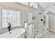 Luxurious tiled walk-in shower with glass surround complemented by a soaking tub and natural light at 5702 Brynwood Nw Cir, Acworth, GA 30101