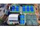 Aerial view of a modern tennis and pickleball complex featuring vibrant blue and green courts and ample parking at 5702 Brynwood Nw Cir, Acworth, GA 30101