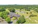 Overhead view of clubhouse, golf course, and a scenic pond on the community grounds at 7045 Parrish Way, Cumming, GA 30040