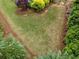 Aerial view of backyard featuring green grass and meticulously maintained garden beds at 7045 Parrish Way, Cumming, GA 30040