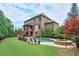 Expansive backyard features an in-ground pool, patio, and a lush green lawn, perfect for outdoor enjoyment at 7045 Parrish Way, Cumming, GA 30040