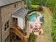 Aerial view of a backyard with pool, patio, fire pit and outdoor kitchen area with lush landscaping at 7045 Parrish Way, Cumming, GA 30040