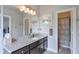Bathroom featuring granite counters, dark wood cabinets, and a shower in the background at 7045 Parrish Way, Cumming, GA 30040