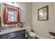 Cozy bathroom with a gray vanity, granite countertop, a toilet, and framed artwork on the wall at 7045 Parrish Way, Cumming, GA 30040