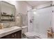 Bathroom featuring a glass shower, a floating vanity, and a large mirror at 7045 Parrish Way, Cumming, GA 30040