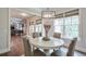 Bright dining area with hardwood floors, large windows, and an elegant light fixture at 7045 Parrish Way, Cumming, GA 30040