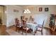 Dining room with wainscoting, hardwood floors, and a rustic wine rack at 7045 Parrish Way, Cumming, GA 30040