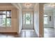 Bright entryway with a front door featuring glass panels and transom windows at 7045 Parrish Way, Cumming, GA 30040