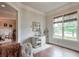Well-lit home office featuring hardwood floors, a desk, and a large window at 7045 Parrish Way, Cumming, GA 30040