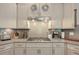 Well-lit kitchen features stainless steel appliances, granite countertops, and white cabinetry at 7045 Parrish Way, Cumming, GA 30040