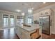 Bright kitchen featuring granite countertops, stainless appliances, and access to the outdoor deck at 7045 Parrish Way, Cumming, GA 30040