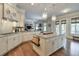 Open kitchen with granite countertops, stainless steel appliances, and a view into the living room at 7045 Parrish Way, Cumming, GA 30040