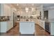 Gourmet kitchen with custom cabinets, stainless steel appliances, and a large center island at 7045 Parrish Way, Cumming, GA 30040