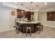 Inviting kitchen with a modern design featuring dark cabinets, marble countertops, and stainless steel appliances at 7045 Parrish Way, Cumming, GA 30040