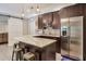 Open-concept kitchen with dark wood cabinetry, a marble countertop island, and stainless steel appliances at 7045 Parrish Way, Cumming, GA 30040