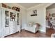 Sitting area with hardwood floors, a comfortable chair, and a decorative cabinet at 7045 Parrish Way, Cumming, GA 30040