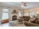 Inviting living room boasts a decorative fireplace, large windows, and comfortable seating at 7045 Parrish Way, Cumming, GA 30040