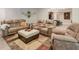 Open living room with comfortable seating, a large area rug, and a kitchenette in the background at 7045 Parrish Way, Cumming, GA 30040