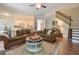 Open-concept living room with hardwood floors, two sofas, and a view into the kitchen at 7045 Parrish Way, Cumming, GA 30040