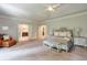 Expansive main bedroom with a sitting area, neutral decor, and ensuite bathroom access at 7045 Parrish Way, Cumming, GA 30040