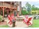 Outdoor living space with a patio, fire pit, and comfortable seating, ideal for entertaining at 7045 Parrish Way, Cumming, GA 30040