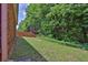 Large backyard with privacy fence and mature trees provides a serene retreat at 735 Scenic Creek Dr, Lawrenceville, GA 30046